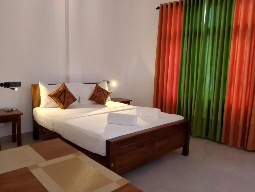 Side room angle with bed and curtains